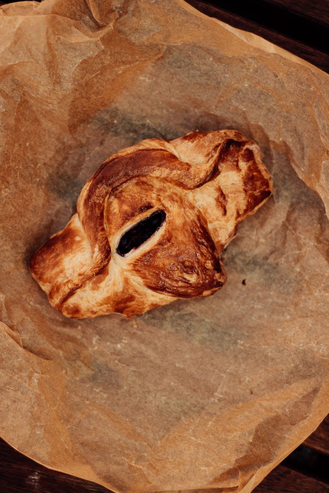 Blueberry-filled pastry on parchment paper