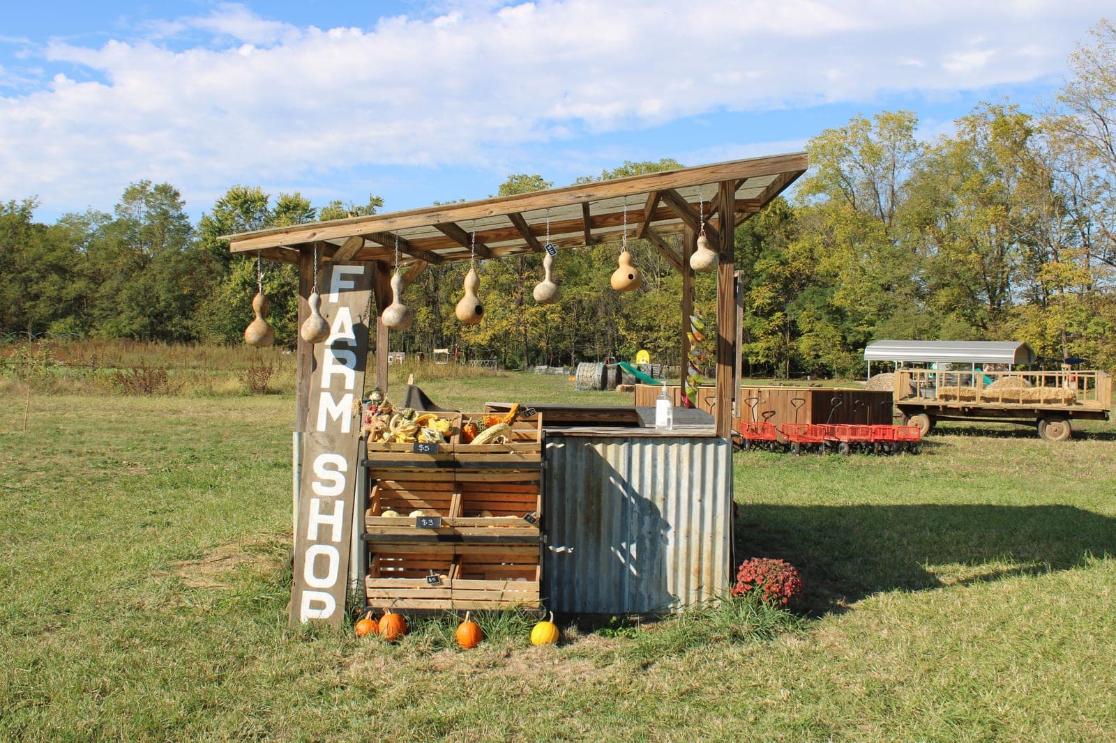 Roadside farm stand with crates of fresh produce for sale