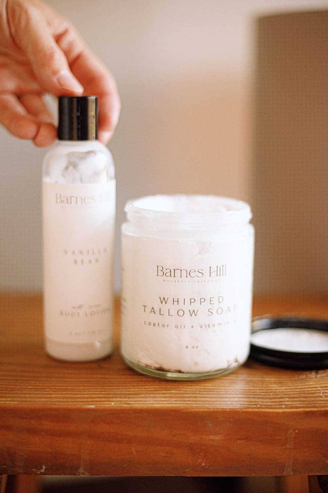 Handmade whipped tallow lotion and soap on a wooden table